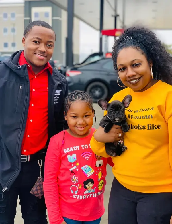 A French Bulldog puppy from Showtime Pups with its new family
